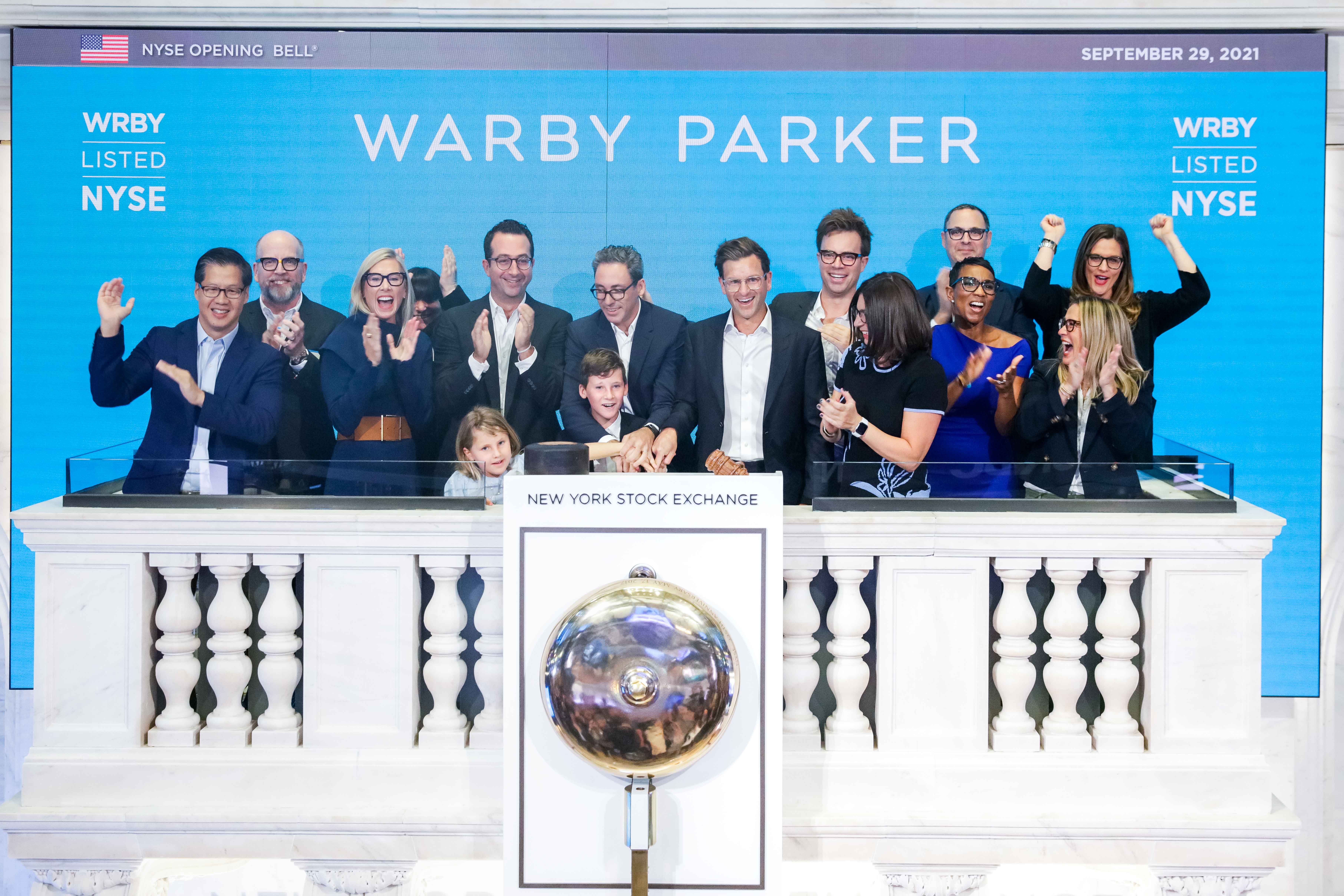 The Warby Parker team on the podium ringing the NYSE opening bell.