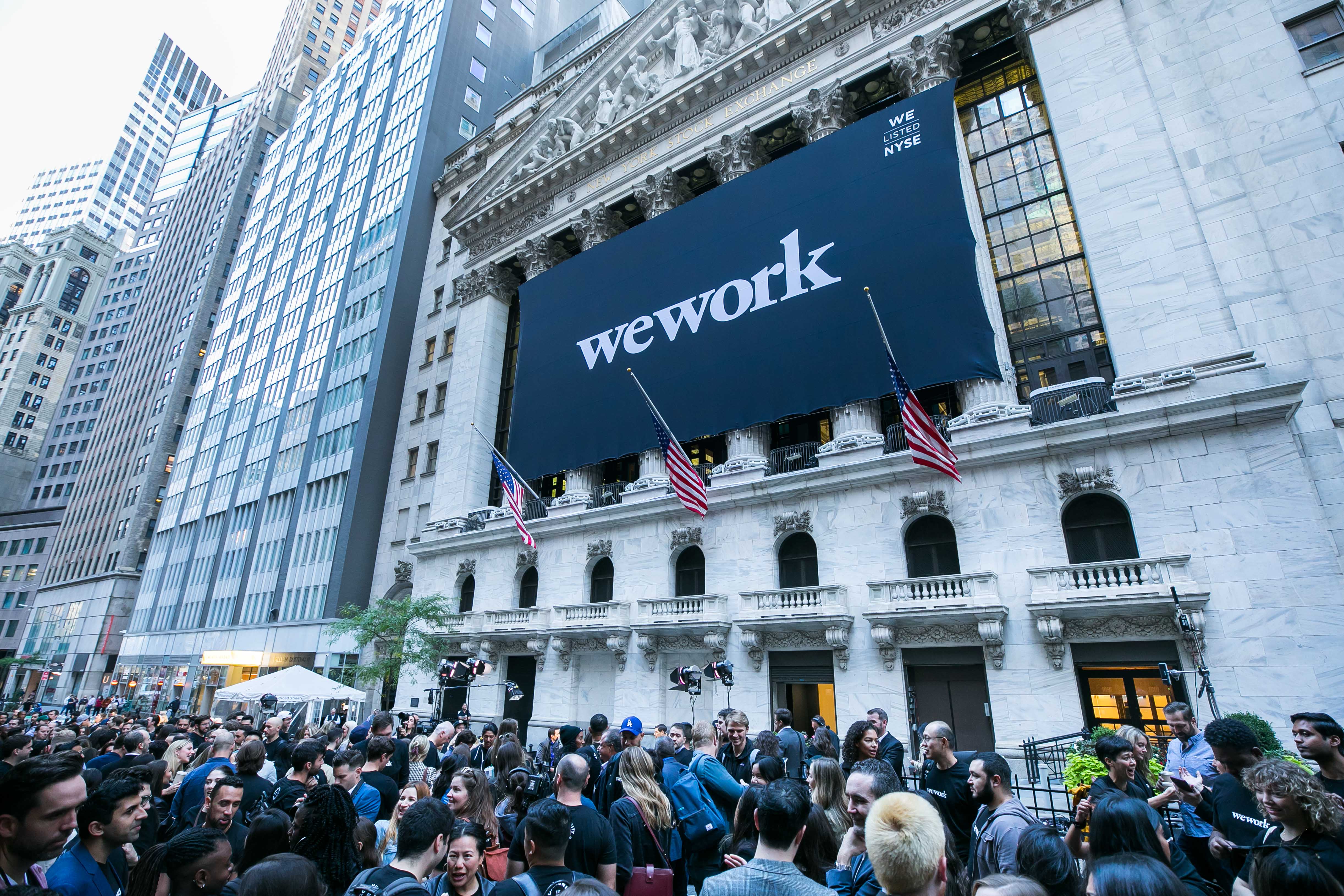 A large crowd celebrates WeWork’s listing